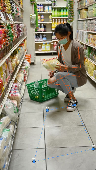 同一畫面疊上橘色的人體骨架線條，地上有藍色四邊形標定框